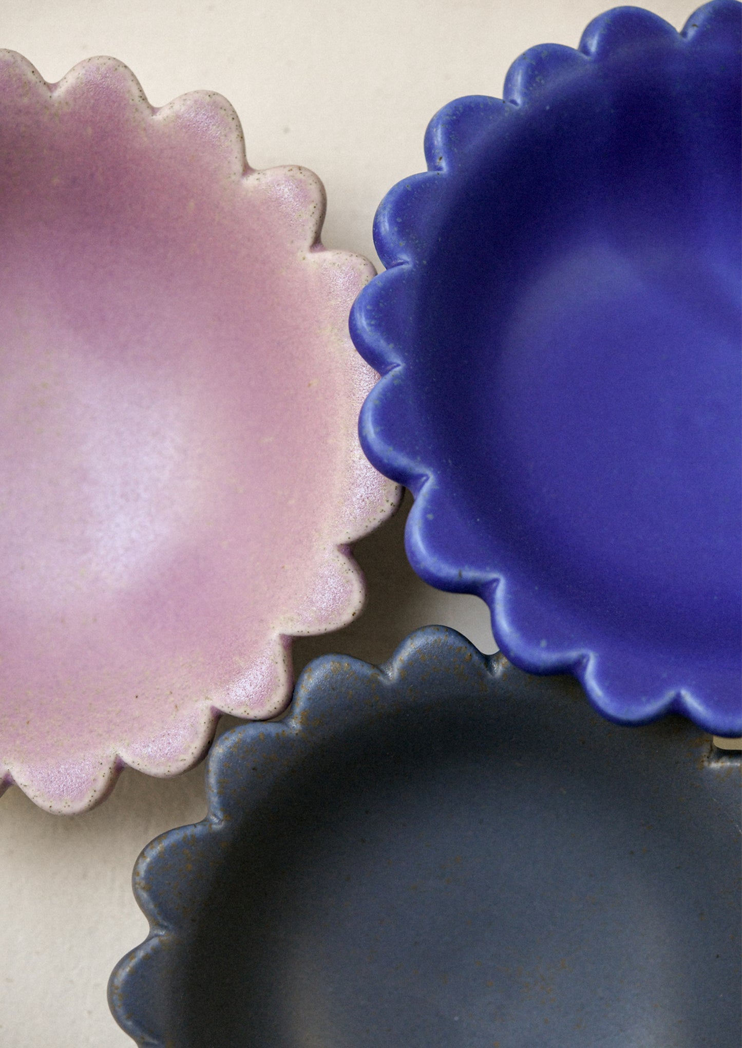 Ceramic scalloped edge bowls in a variety of colors.