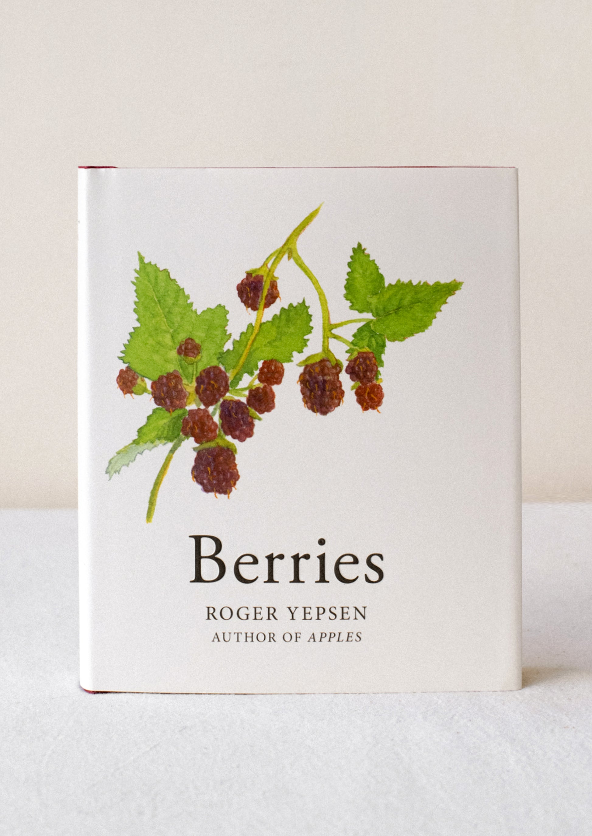 A small hardcover book titled "Berries" with raspberry illustration.