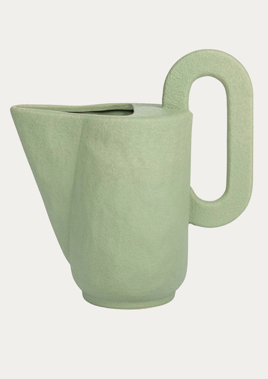 Mint green ceramic pitcher with exaggerated, sculptural shape.