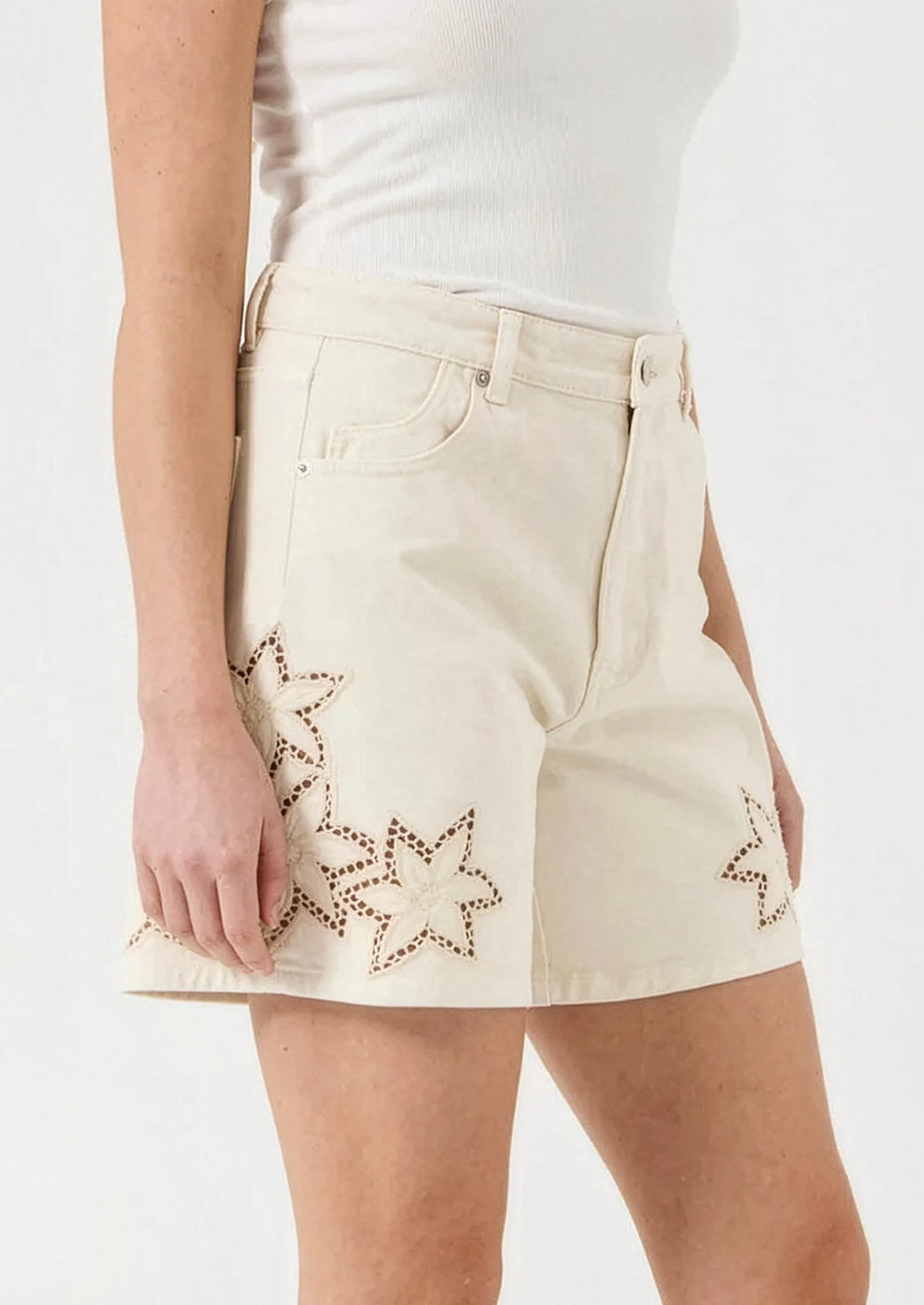 Beige shorts with star patterns on a white background