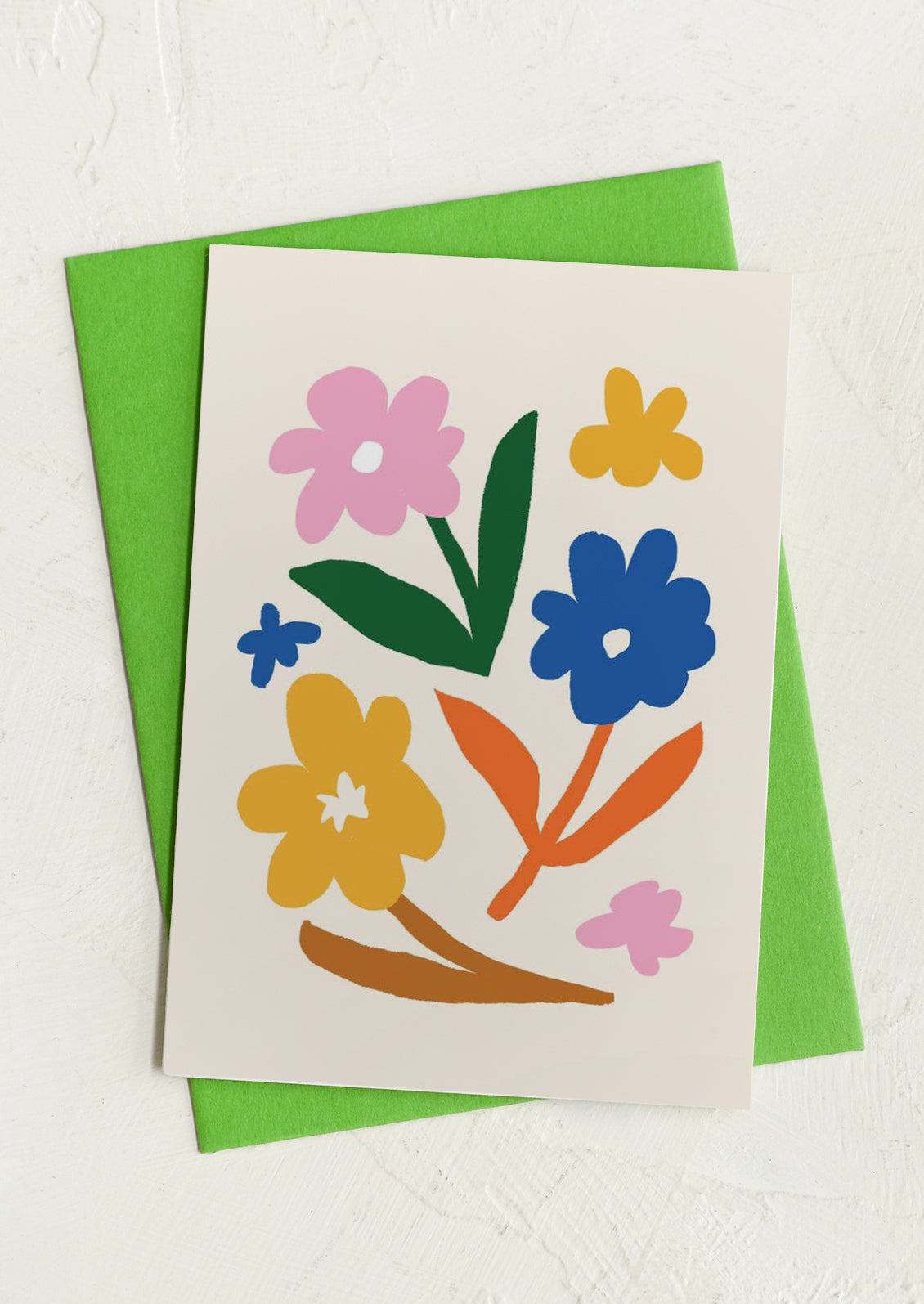 Card with colorful floral design on a green envelope.