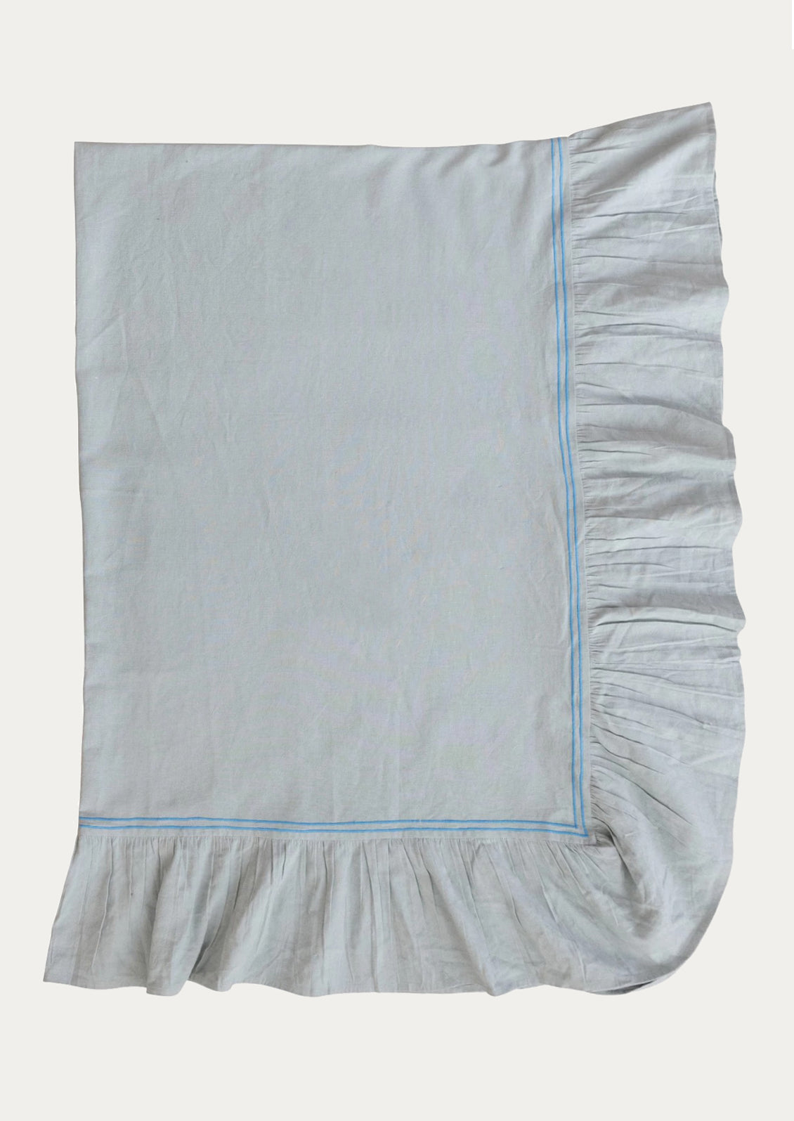 Light blue ruffled tablecloth on a white background