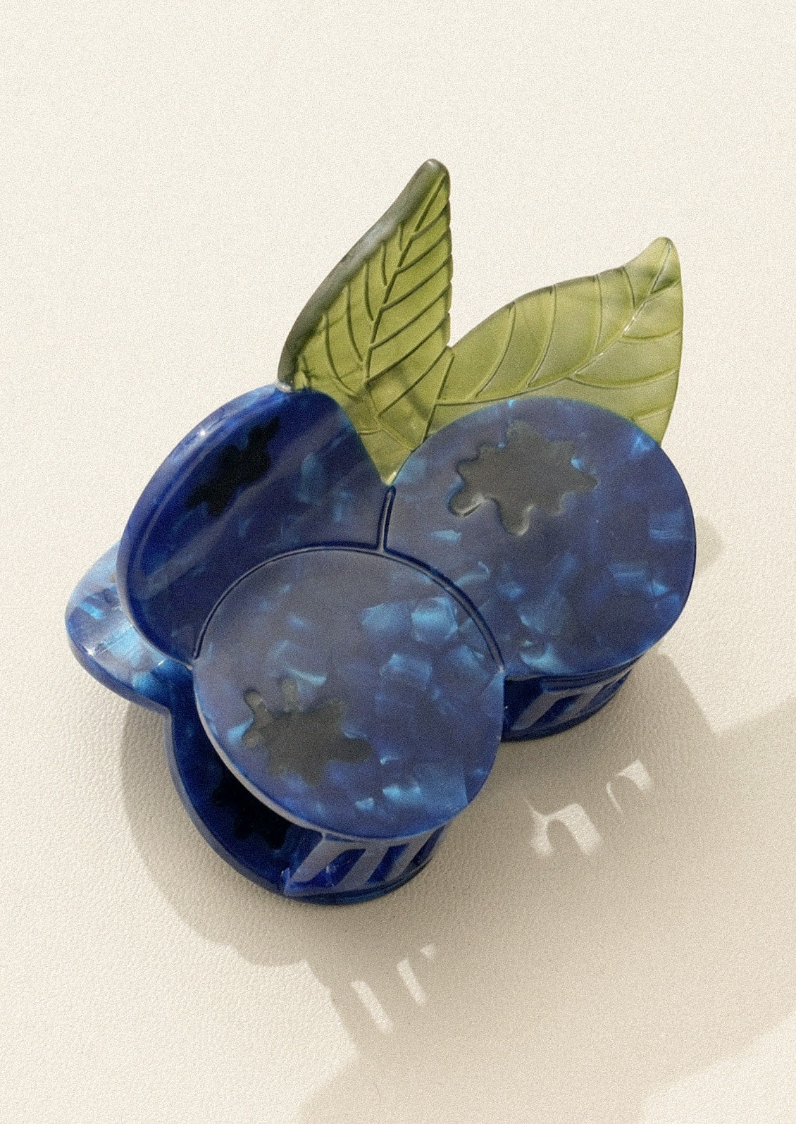 Decorative blueberry hair claw on a white background