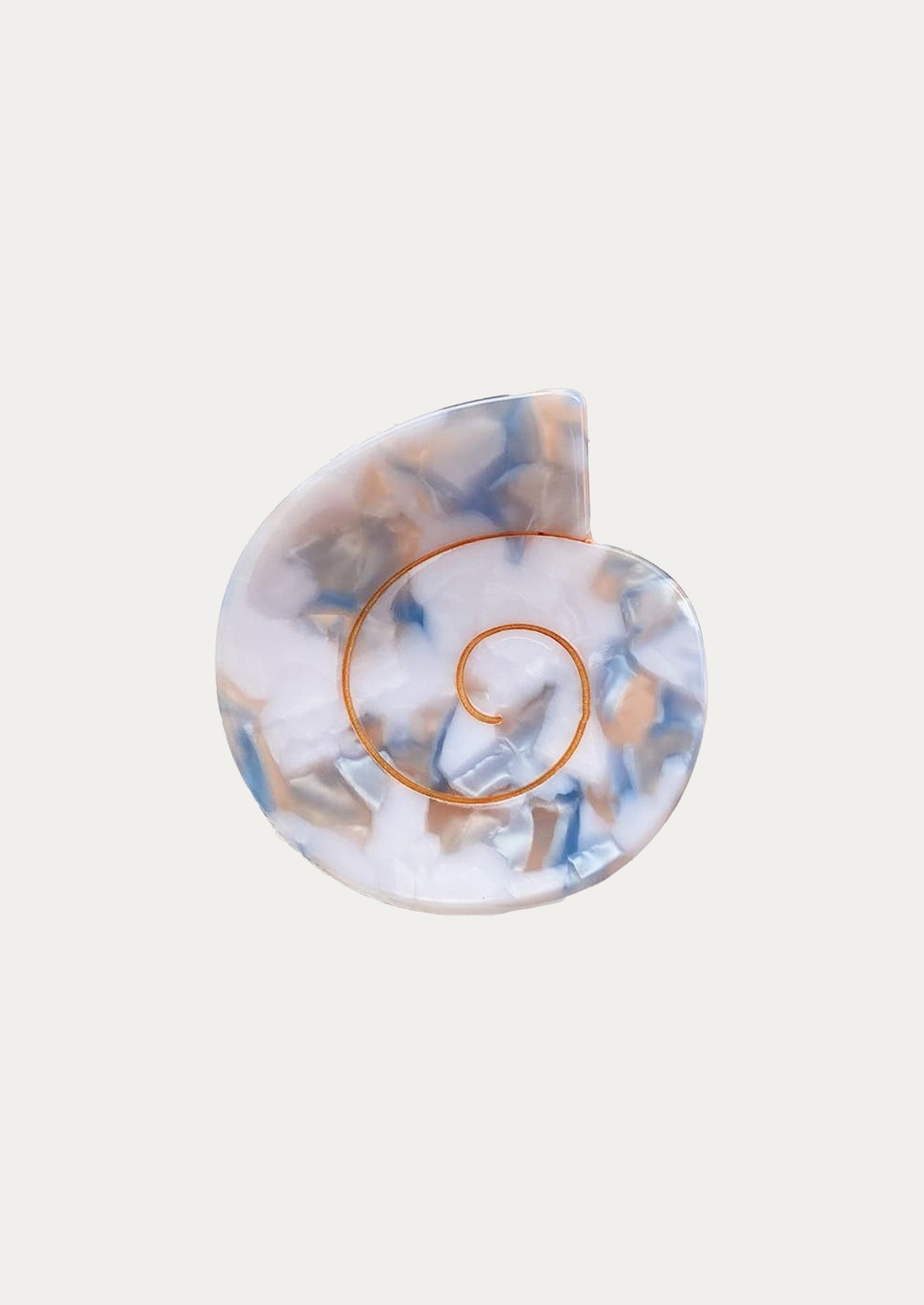 A nautilus shaped hair clip in blue and white marble.