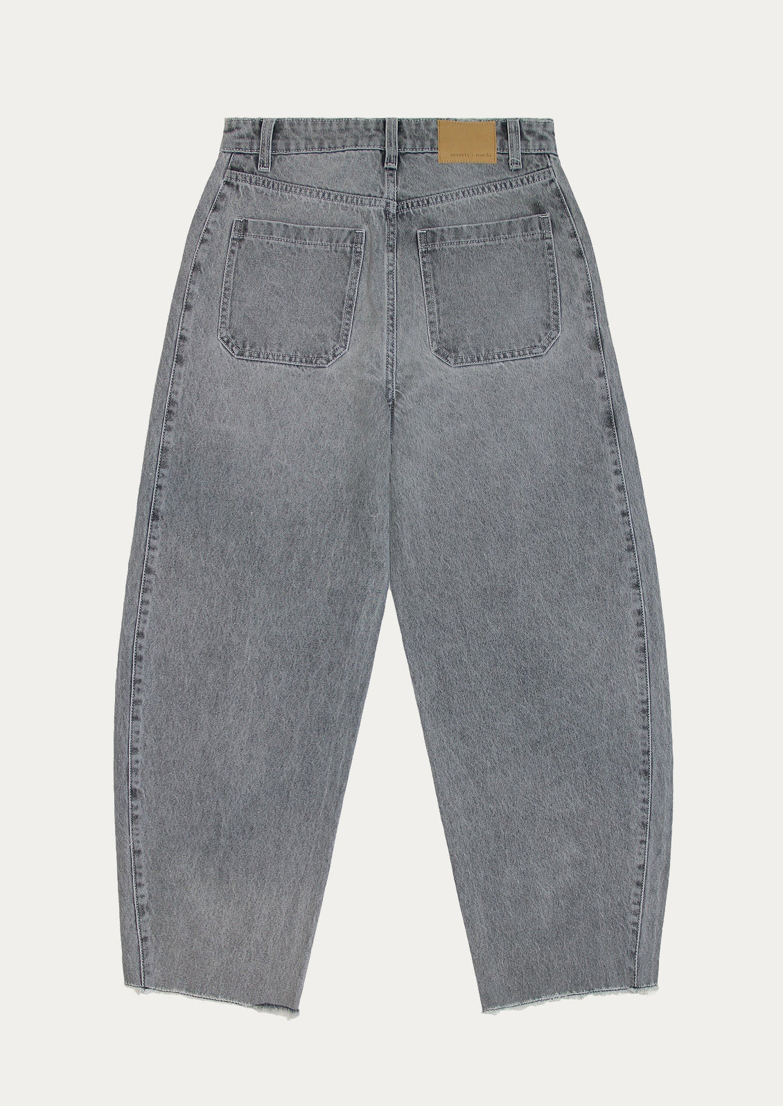 A pair of barrel leg jeans in grey wash.