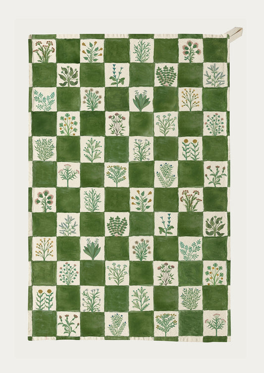 Green and white checkered towel with plant patterns on a white background