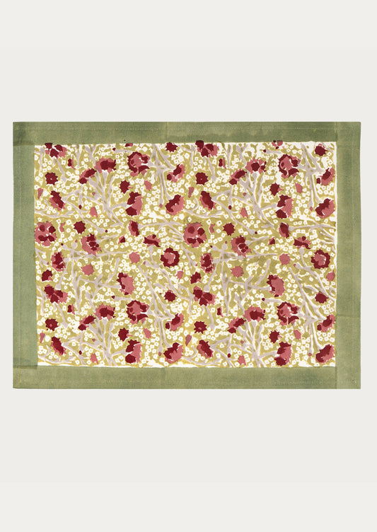 Floral patterned fabric with a green border on a white background