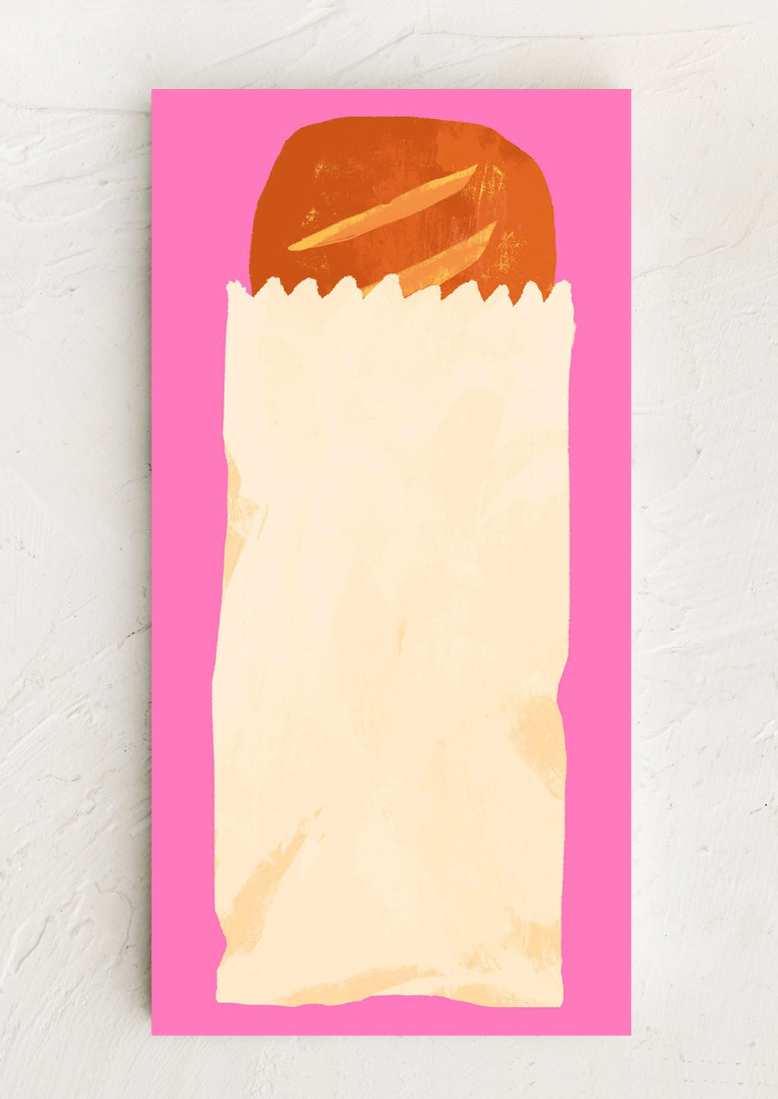 Bread in a paper bag on a pink notepad with a white background