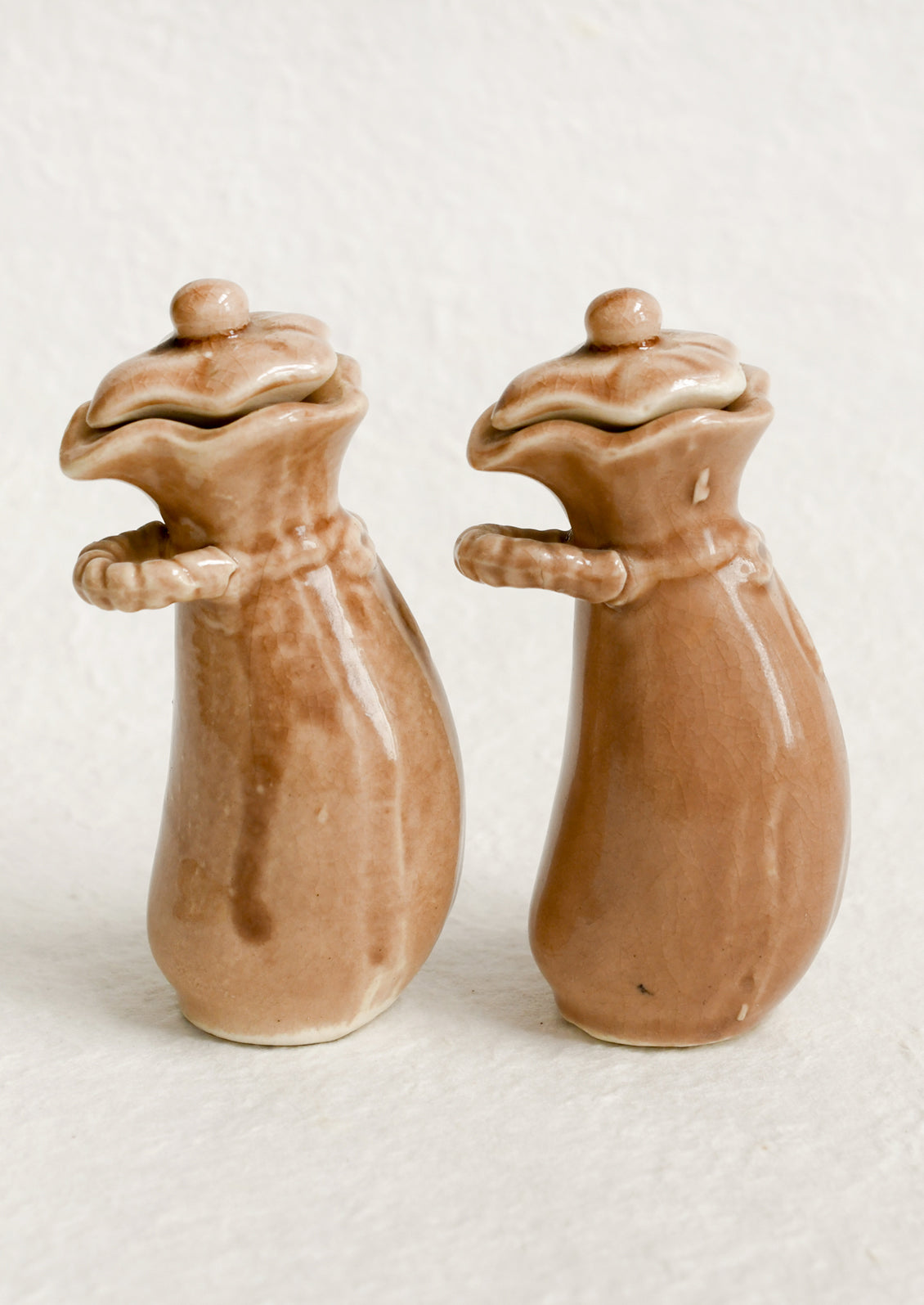 A pair of ceramic oil & vinegar cruets in the shape of bushel baskets.