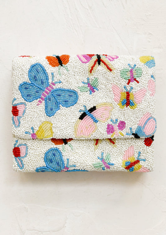 Beaded clutch with colorful butterfly pattern on a white background