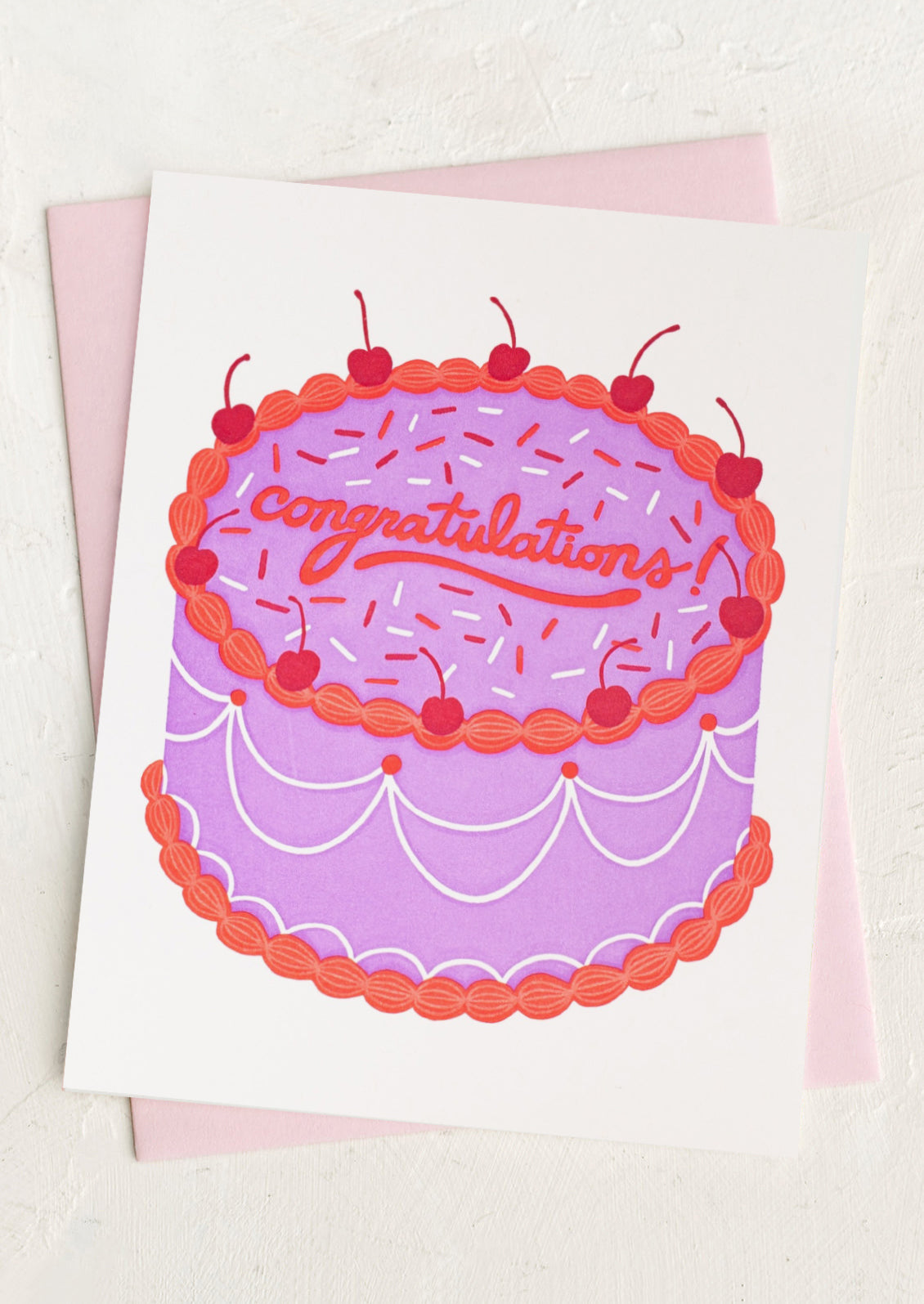 Greeting card with a purple cake illustration and 'Congratulations' text on a white background.