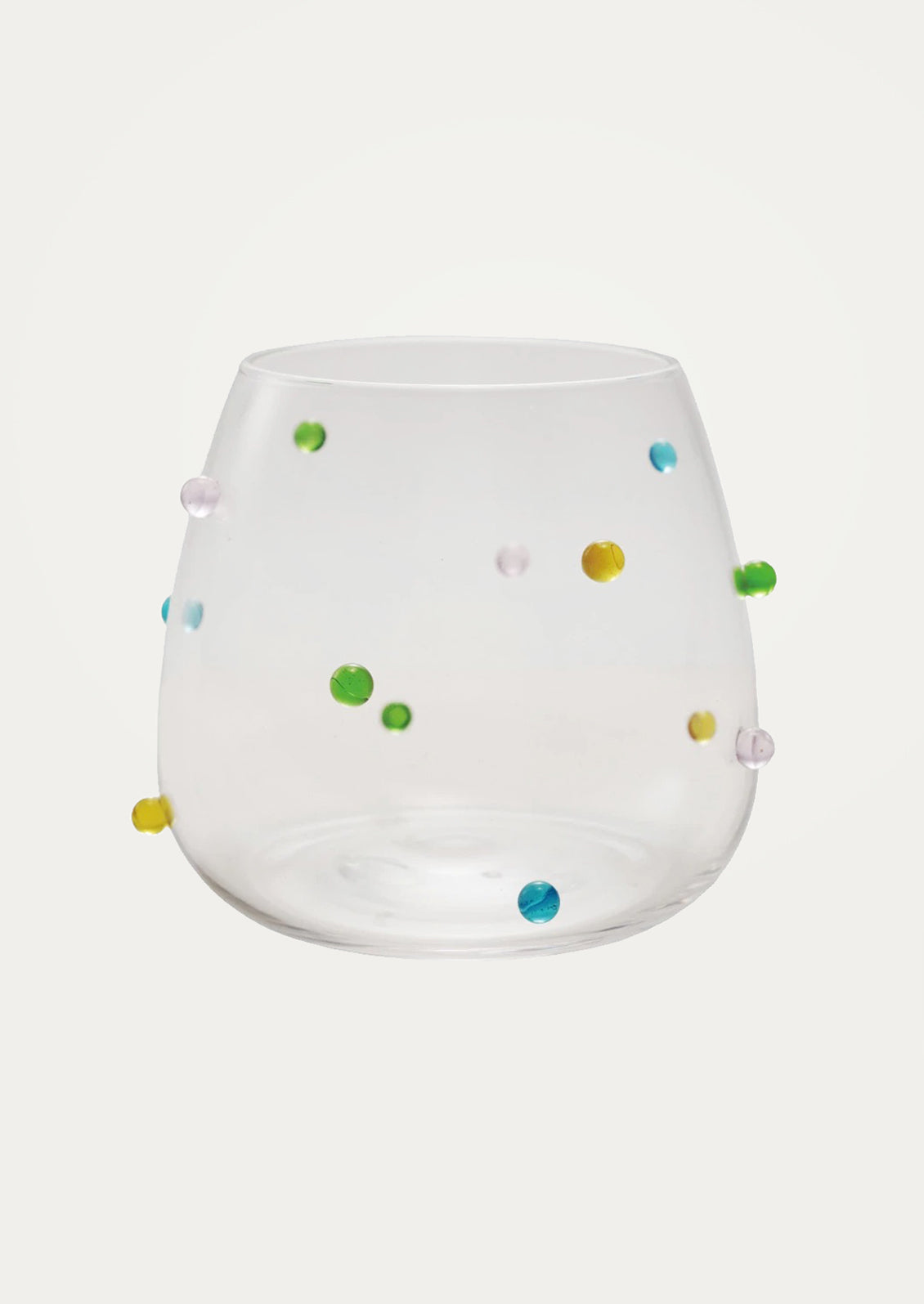 A clear glass tumbler with colorful raised "dots" on outside of glass.