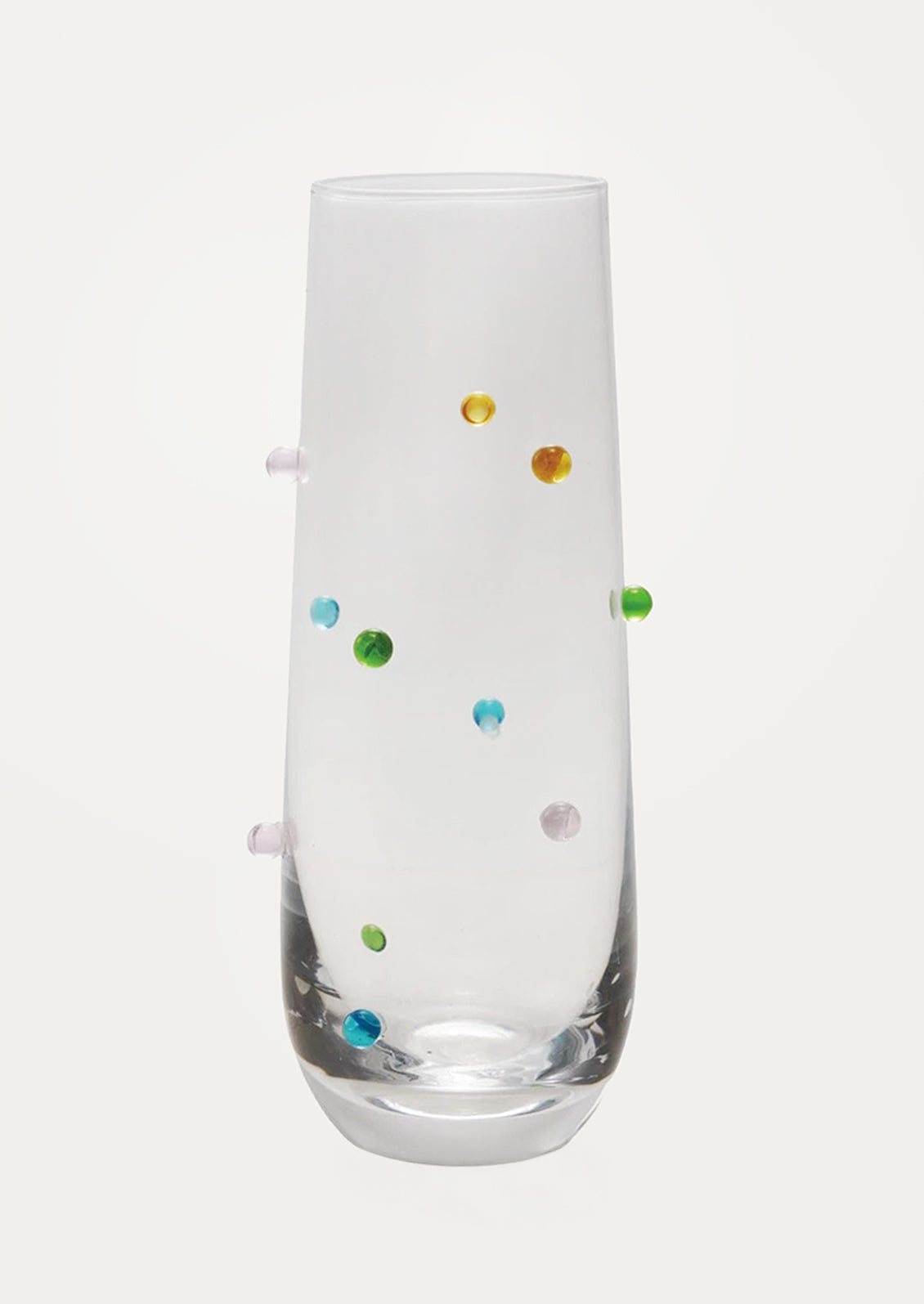 A clear glass flute with colorful raised "dots" on outside of glass.