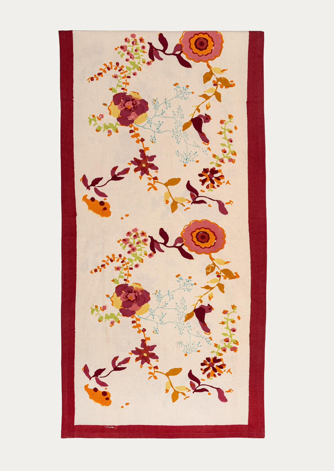 Floral patterned fabric with a red border on a white background