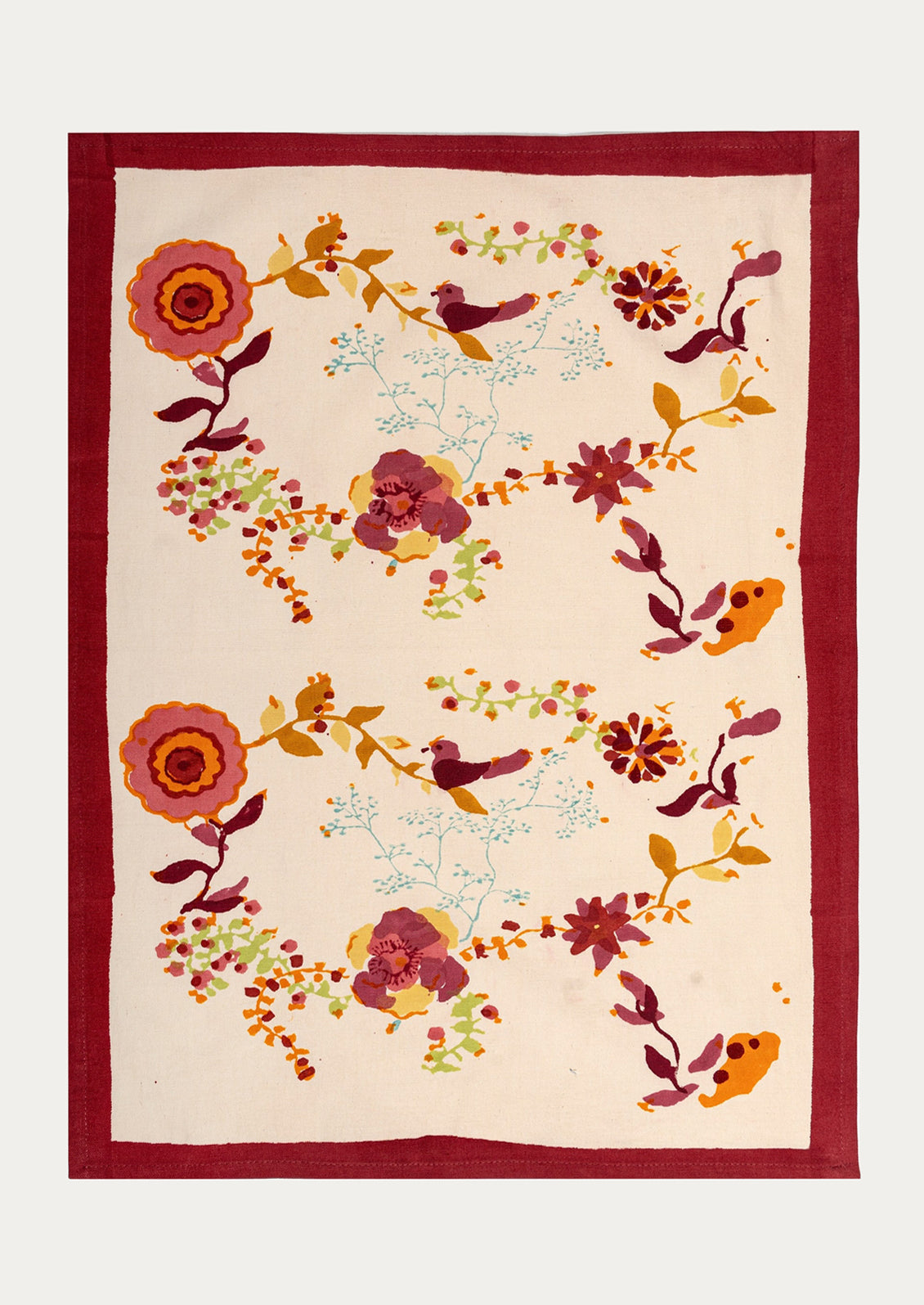Decorative tea towel with floral and bird pattern on a beige background