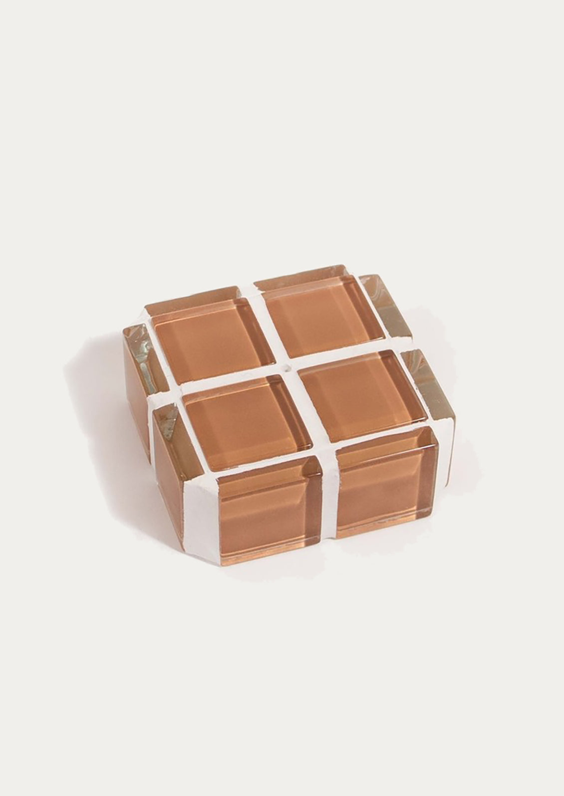 A square cube shape incense holder made up of brown glass tiles.