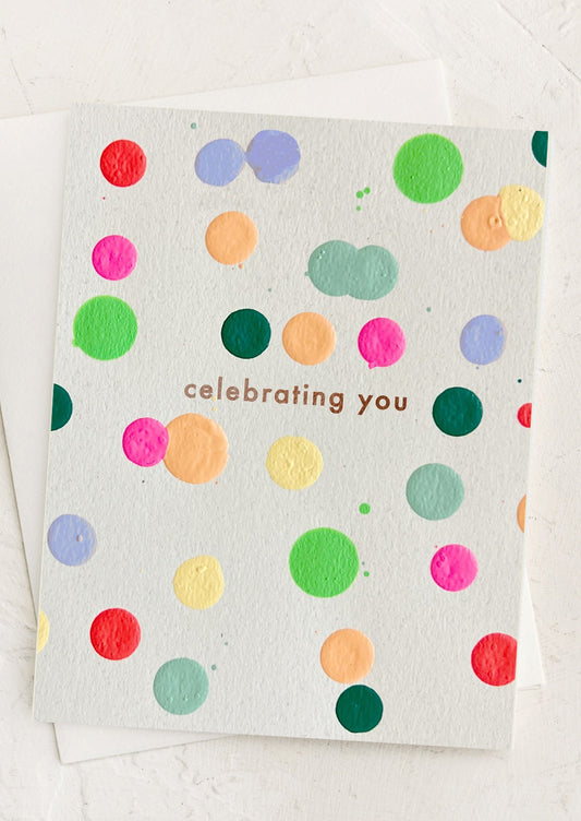 A card with colorful dots reading "Celebrating you".