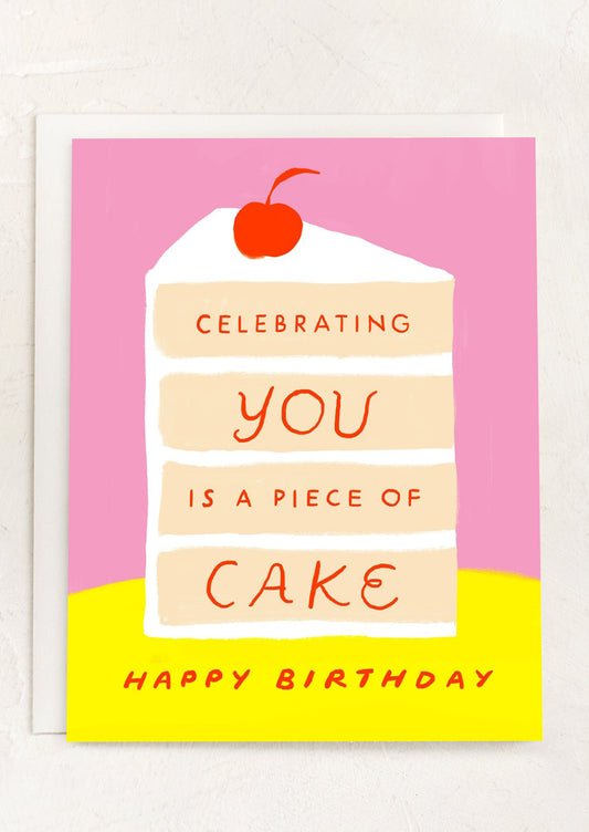 A greeting card with illustration of layer cake, text reads "Celebrating you is a piece of cake - Happy Birthday".