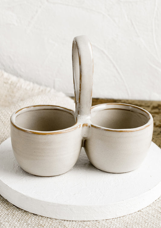 A double cellar ceramic vessel in off-white glaze.