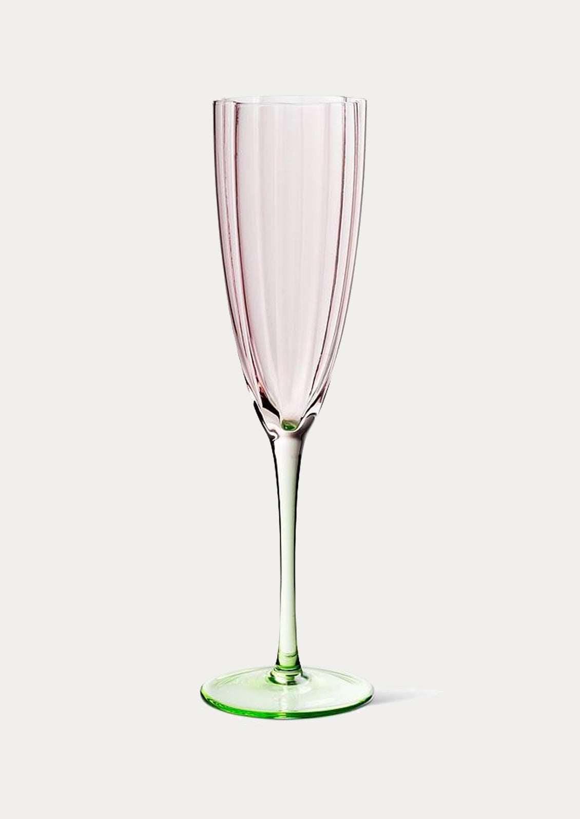 A champagne glass in shape of tulip with pink top and green bottom.