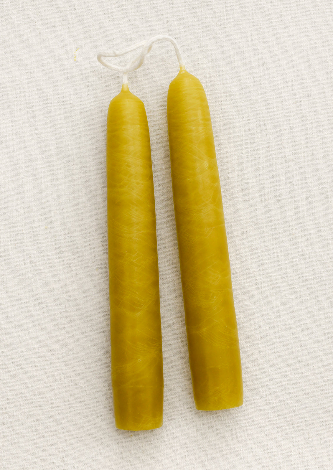 A pair of short taper candles in shade Chartreuse.