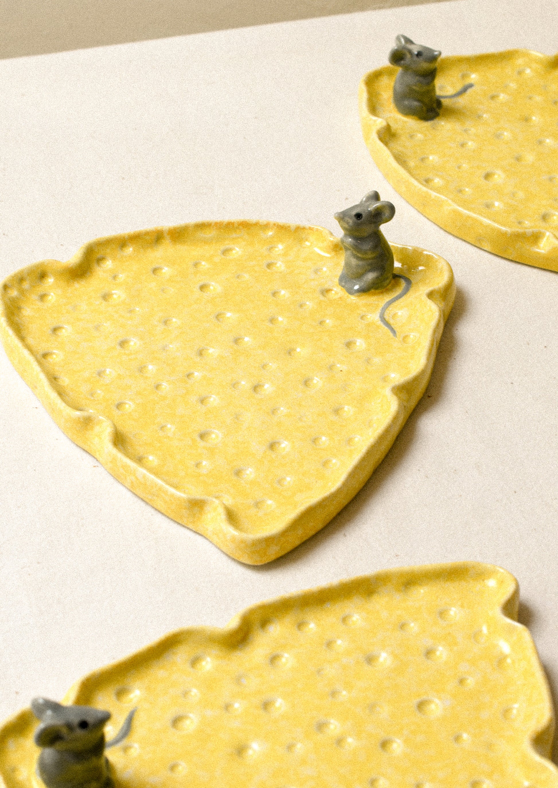 Ceramic cheese plates with 3d mouse detail.