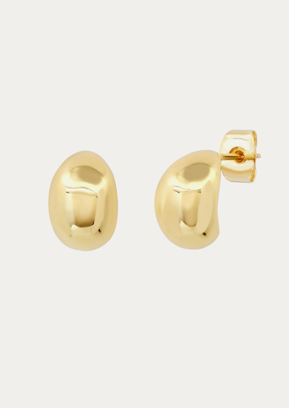 A pair of gold teardrop shaped earrings.