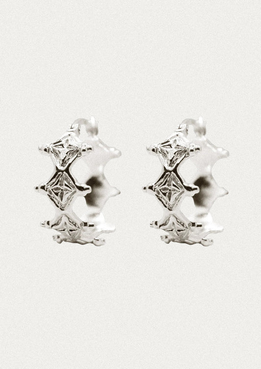 A pair of sterling silver hoop earrings with a unique diamond-like design.