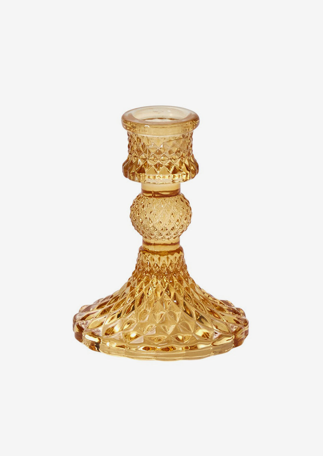 A glass candlestick holder in facet textured glass, honey color.