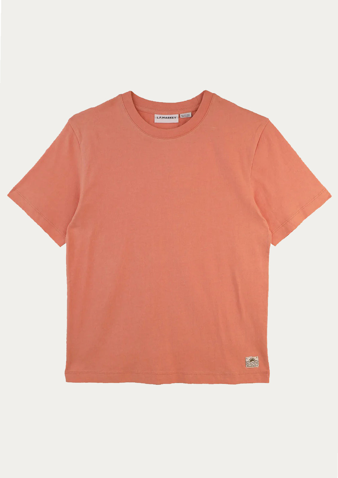 Coral t-shirt on a light gray background