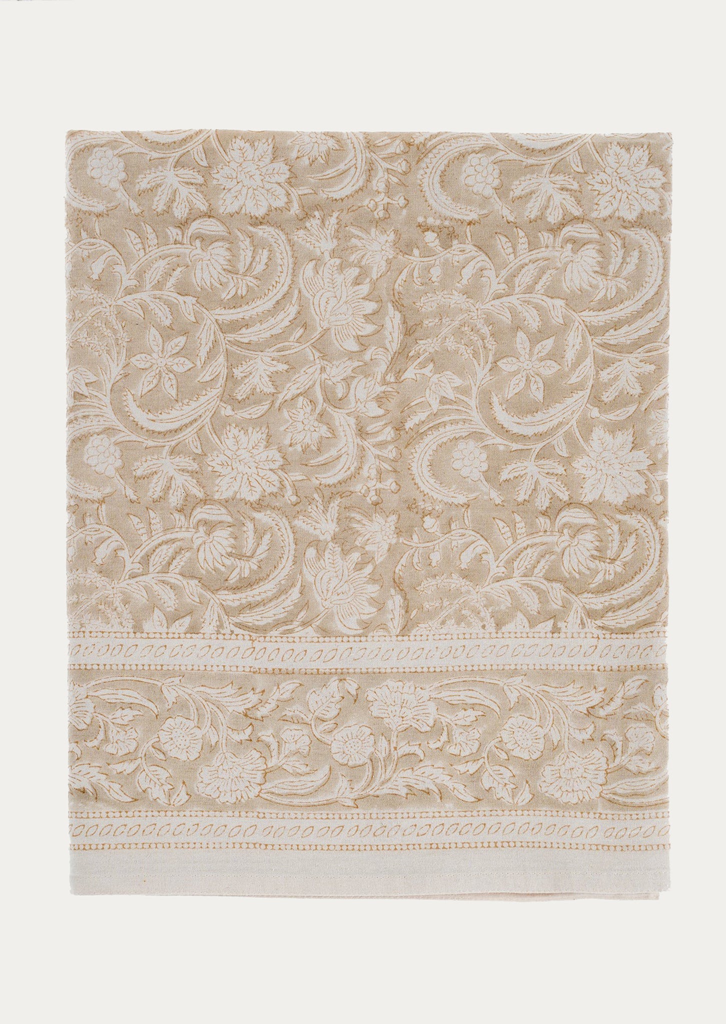 A tablecloth in neutral beige and ivory floral paisley block print pattern.