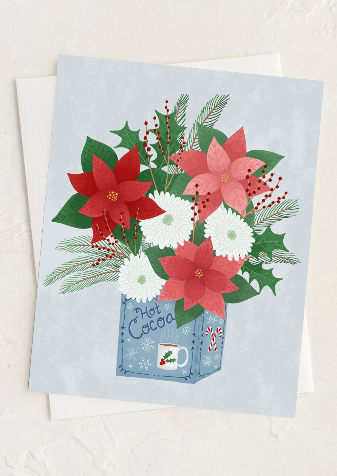 Card with poinsettias and hot cocoa design on a light blue background