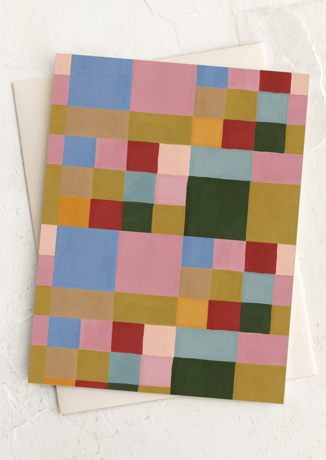 Colorful checkered card with a white envelope on a light background