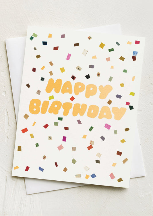A card with image of confetti spray, text reads "Happy Birthday".