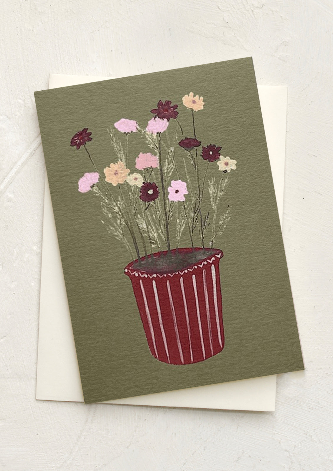 A mini greeting card in olive green with illustration of cosmos flowers in striped pot.