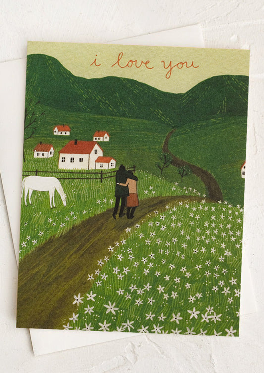 A card with illustration of couple walking through the countryside, text reads "I love you".