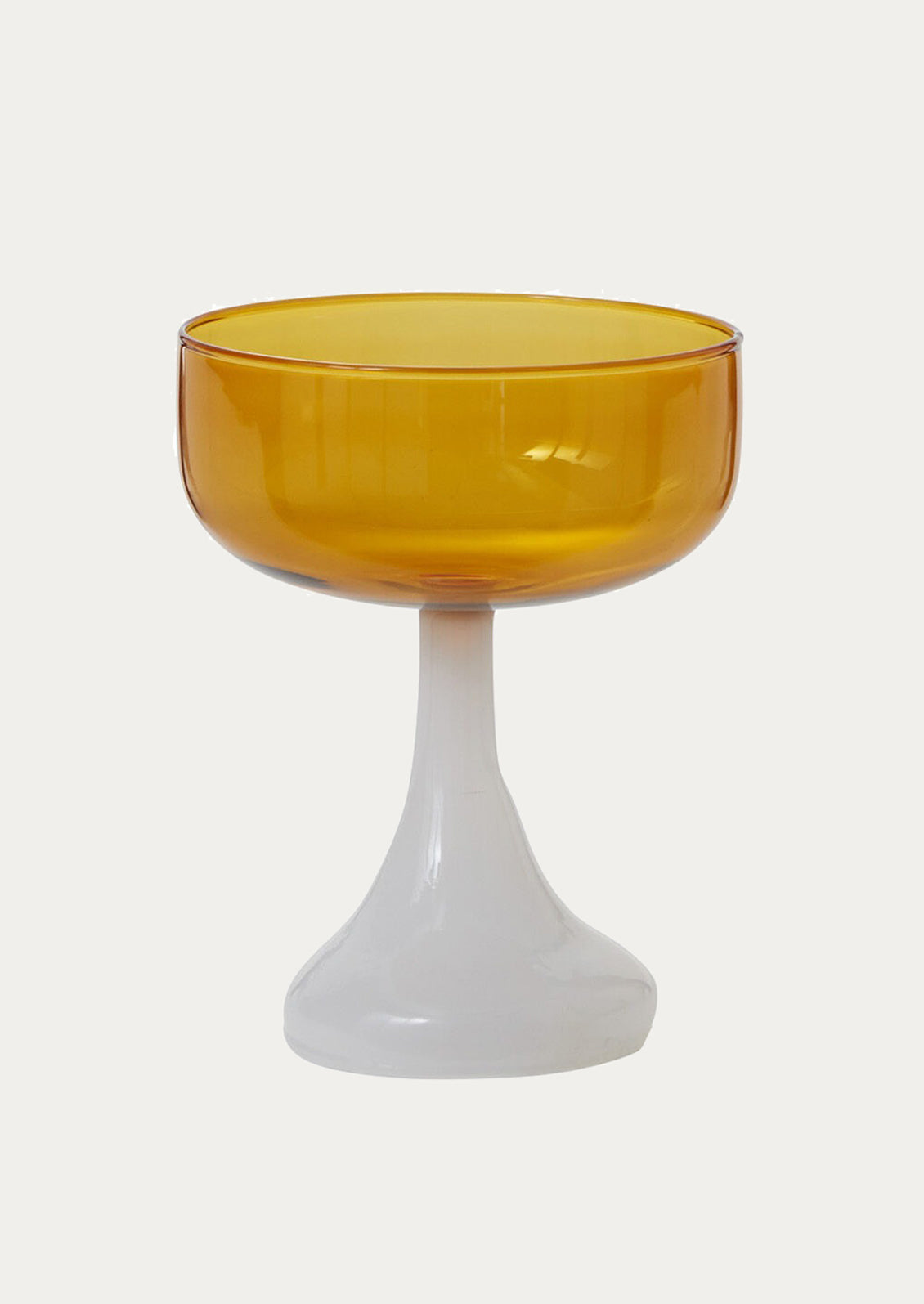 Yellow glass coupe glass with opaque white base.