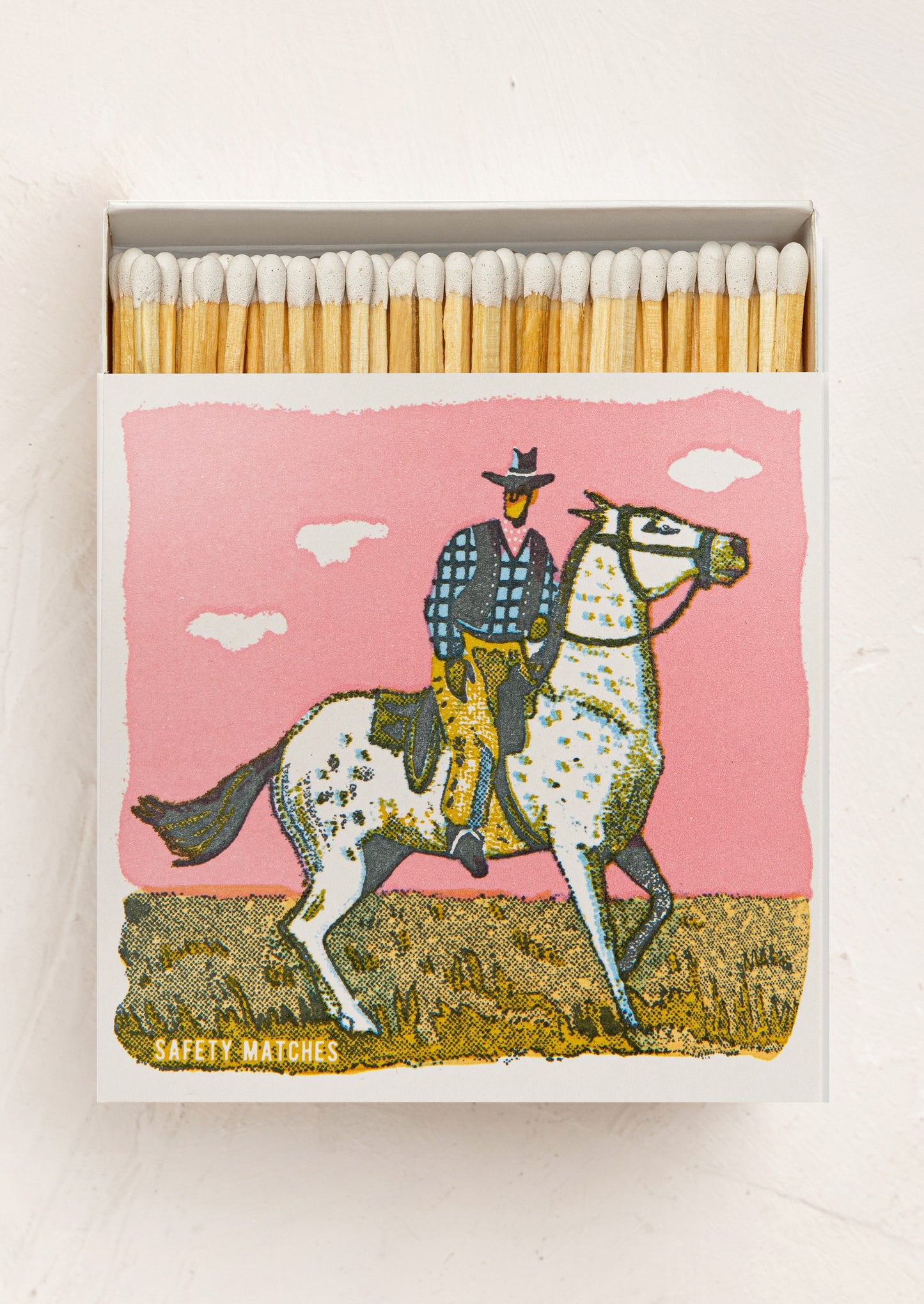 Matches with a cowboy on a horse design on a pink background
