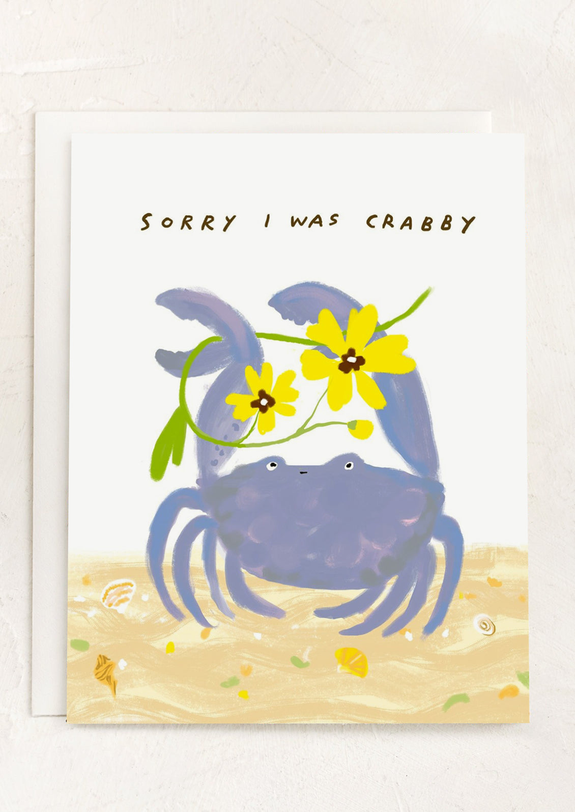A card with illustration of crab holding a flower, text reads "Sorry I was Crabby".
