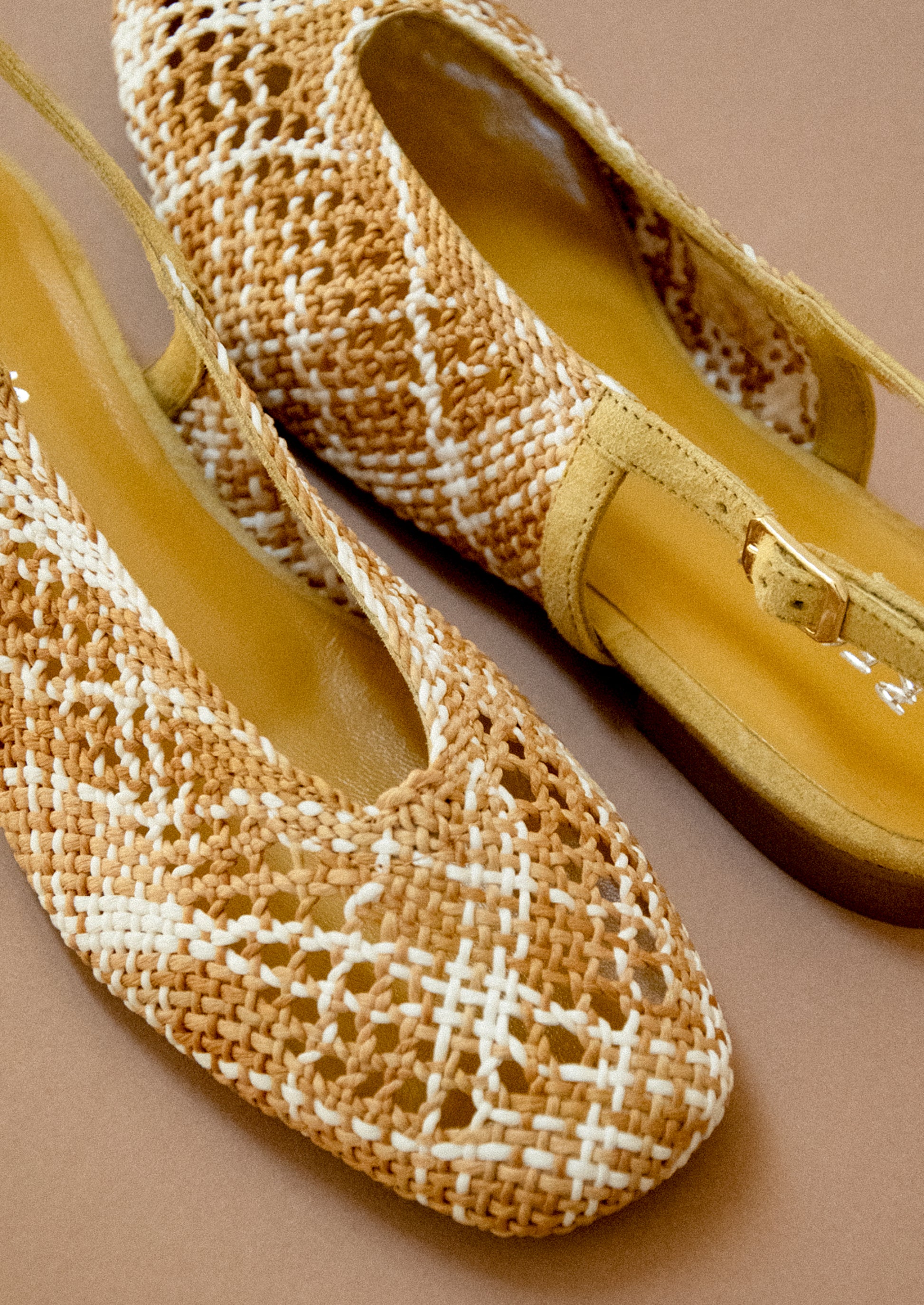 A pair of crochet slingback heeled sandals.