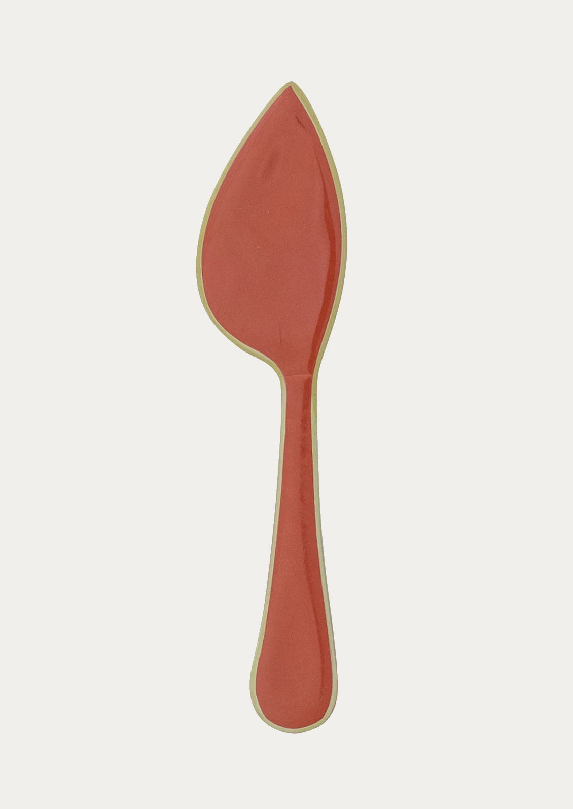 A curved shaped cheese knife in coral with green edge.