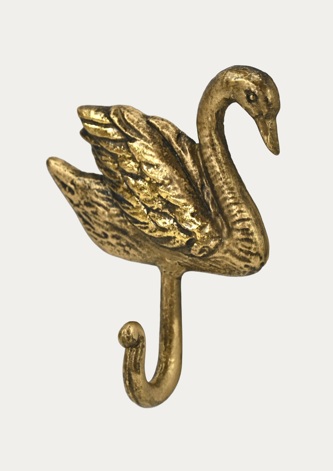A handcrafted gold cast iron wall hook in the shape of a swan on a white background.