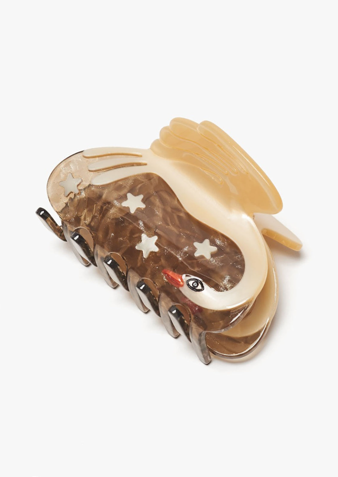 A hair claw with stars next to white swan pattern.