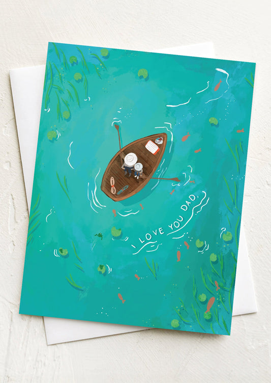 A card with image of aerial view of two people in a canoe, text reads "I Love You Dad".