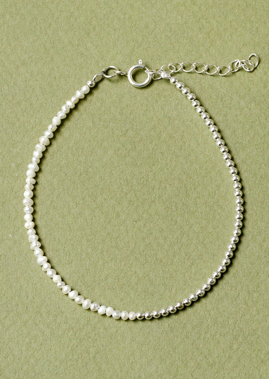 A bracelet with sterling silver beads and small freshwater pearls.