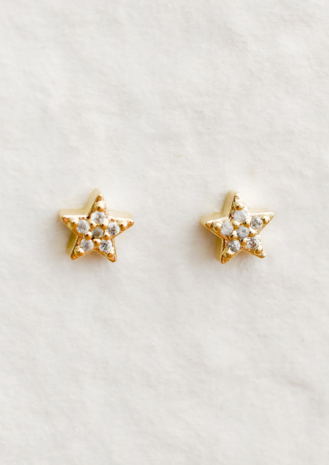 A pair of small star shaped stud earrings with allover crystal detailing.
