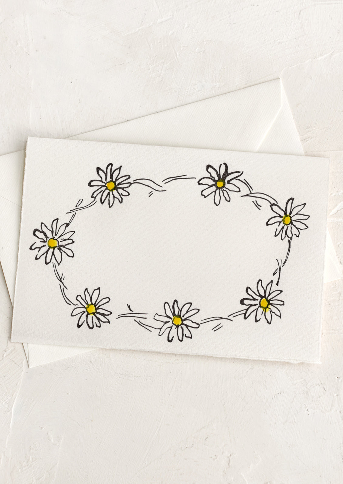 A greeting card with hand drawn image of a daisy chain, no text.
