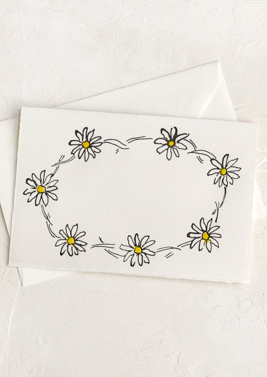 A greeting card with hand drawn image of a daisy chain, no text.