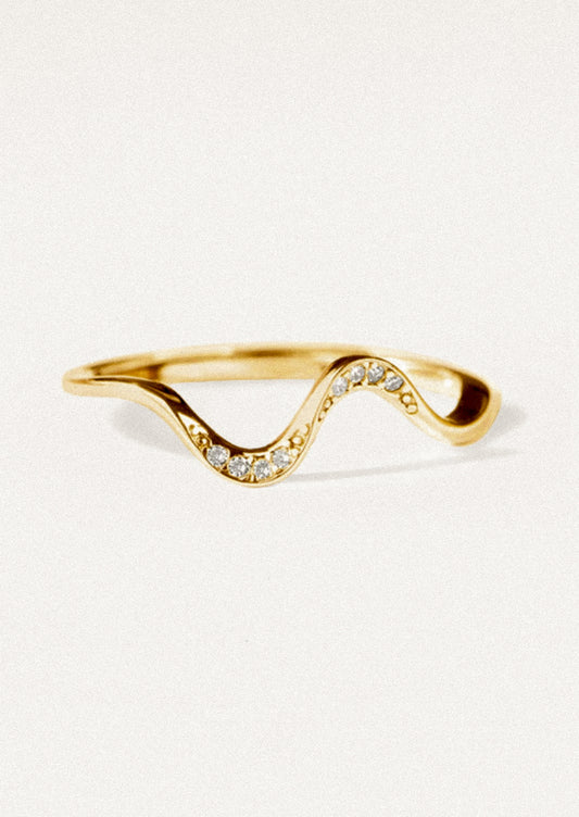 A wavy gold ring with crystal detailing.