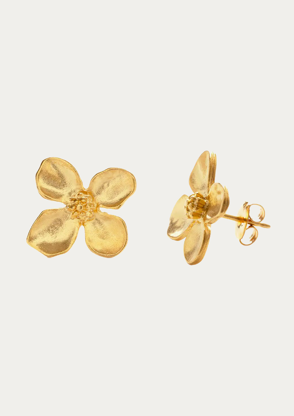 A pair of gold earrings in the shape of a flower with four petals.